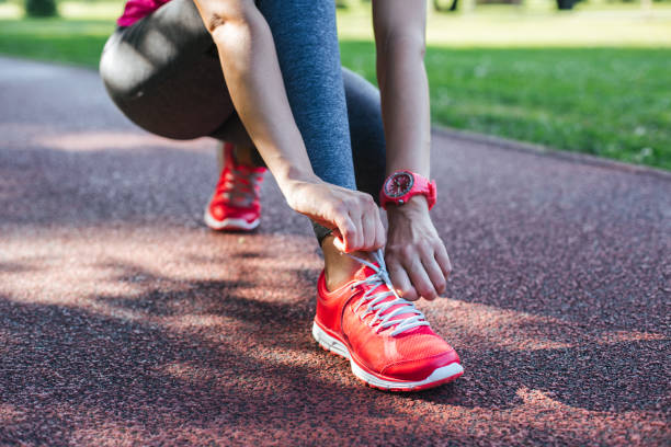 istock sportswoman tying shoelaces 1048454410