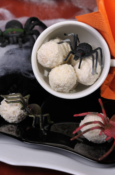 candies in the form of spider eggs in a cup on the table in halloween - eggs animal egg stack stacking imagens e fotografias de stock