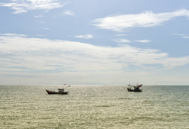 istock Fisherman boat at sea with blue sky background 1048460494