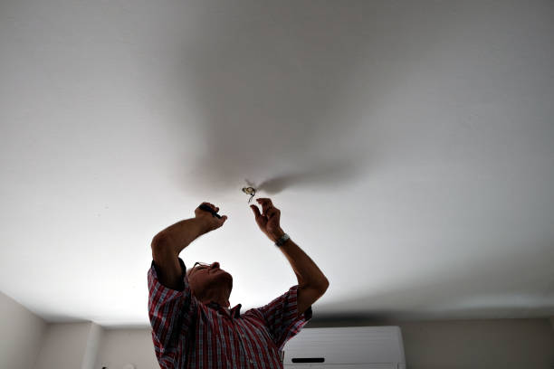 istock Adult man assembling electricity after moving 1048461044