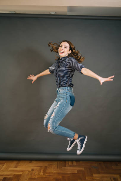 istock Gorgeous smiling girl jumping 1048461300