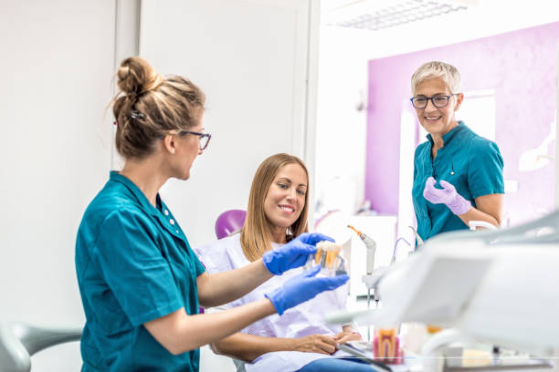 istock Woman Dentist with patient 1048464436