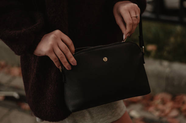 istock Woman closing her bag outdoors closeup 1048467128