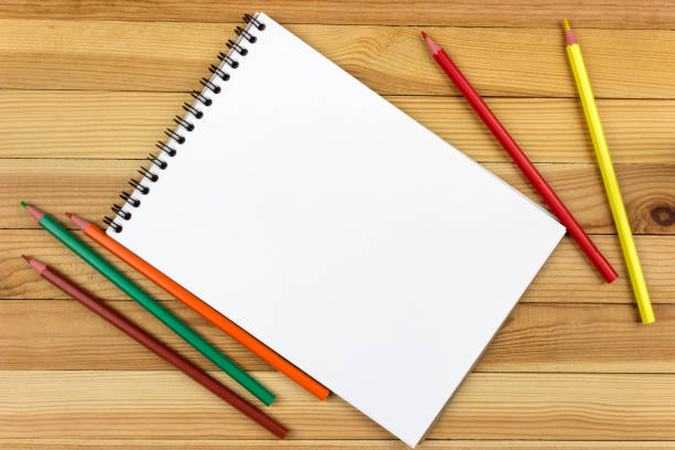 istock on a wooden table is a notepad with colored pencils 1048474284