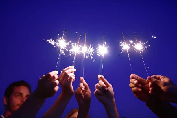 istock hands holding sparklers at blue night 1048474878