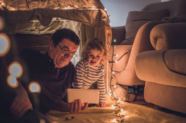 istock Enjoying in a tent with my grandfather 1048477546