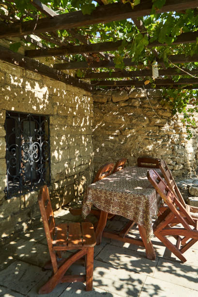 istock Old fashioned Cafe terrace with tables, chairs and trees 1048477604