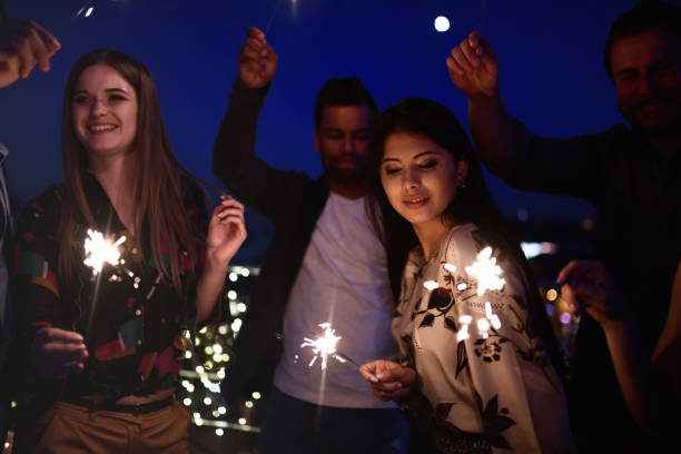 istock young people dancing with sparklers at blue night 1048477980