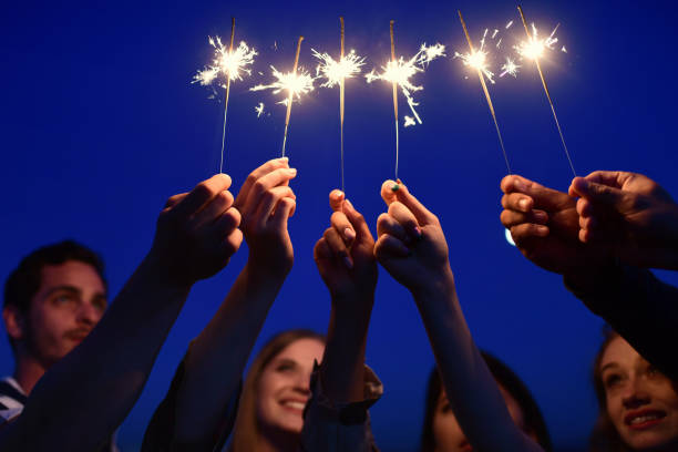 istock young people holding sparklers at blue night 1048482630