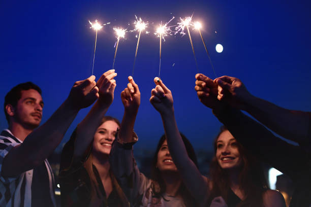 istock young people holding sparklers at blue night 1048482810