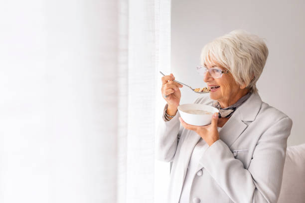 istock Senior woman having healthy breakfast 1048488340