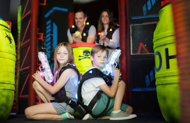istock Kids sitting back to back with laser guns 1048492060