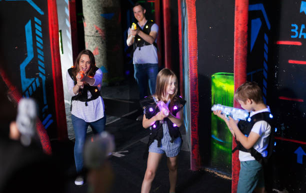 istock Kids and adults on lasertag arena 1048492126