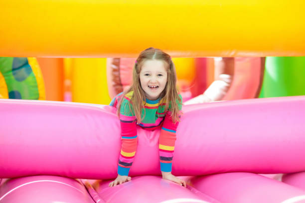 istock Child jumping on playground trampoline. Kids jump. 1048492338