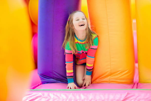istock Child jumping on playground trampoline. Kids jump. 1048494726