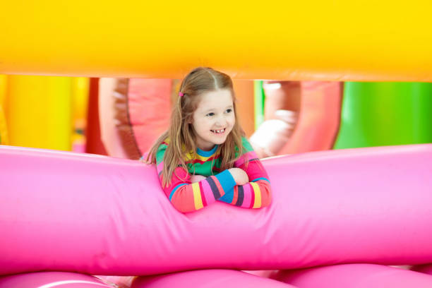 istock Child jumping on playground trampoline. Kids jump. 1048494770
