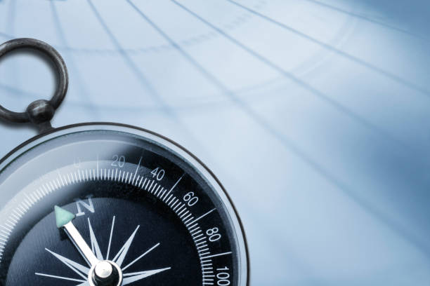istock Shadow Of Latitude And Longitude Cast Across Surface And Compass 1048497286