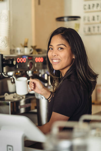istock Young female Barista making coffee 1048509858