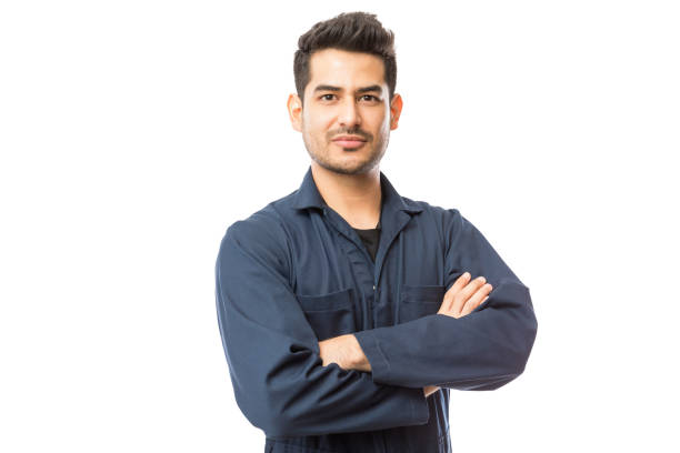 istock Confident Mechanic Standing Arms Crossed Against White Background 1048532124