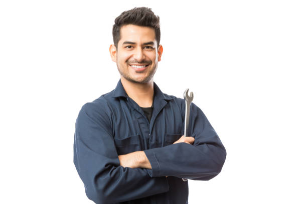 Mechanic With Wrench Standing Hands Folded On White Background Smiling auto mechanic with wrench standing hands folded on white background repairman stock pictures, royalty-free photos & images