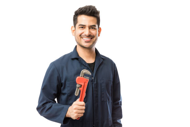 istock Plumber Holding Stillsons While Smiling Against White Background 1048532194