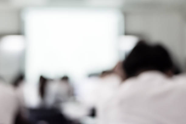 istock Blur school background back view university students writing answer doing exam in classroom 1048544890