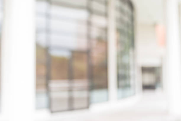istock Office or university building blur background exterior view with blurry empty lobby space, entrance hall glass wall window and light bokeh 1048544894