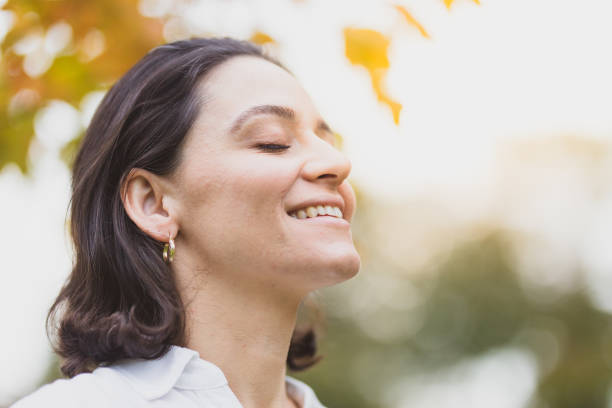 istock Smiling woman with sunset in the background 1048548148