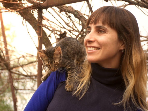 istock young woman with cat 1048549044