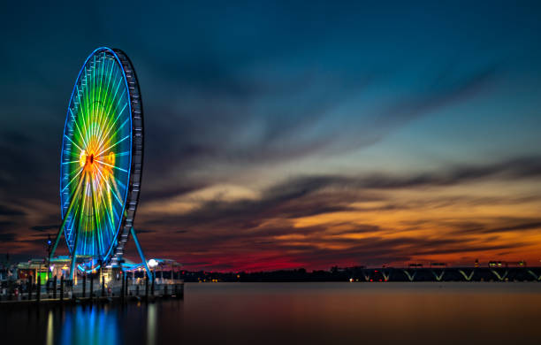 istock Ferris Wheel on the Pier During Sunset 1048570788