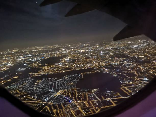 istock mobile camera image capture from the window viewpoint inside airplane showing night cityscape 1048576570