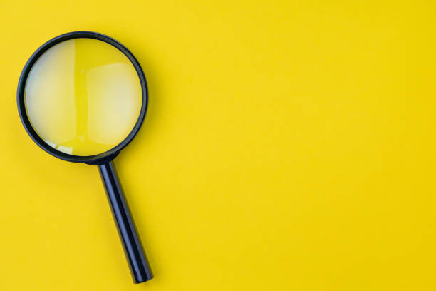 Black magnifying glass, magnifier on yellow background with copy space using as search, transparent, science discovery or SEO concept