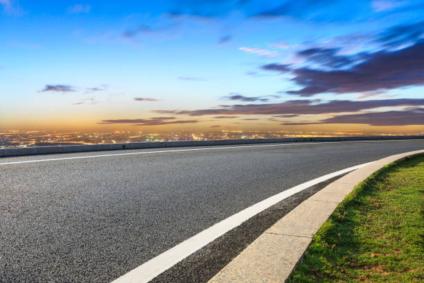 istock Modern city skyline and buildings with empty road at sunset 1048577126