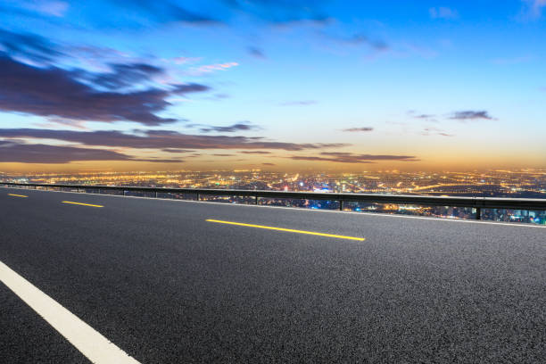 istock Modern city skyline and buildings with empty road at sunset 1048579434