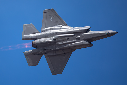 The every distinctive shape of  a F-35 Lightning II  with afterburner on ( very close  bottom view)