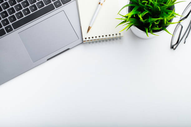 istock Stylish office table desk. Workspace with laptop, diary, succulent on white background. Flat lay, top view with copy space for text 1048584276