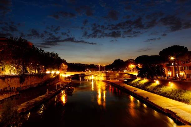 istock Night time view up the Tiber River, Rome, Italy 1048587242