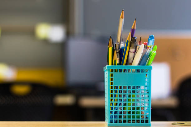 istock Back to school - pen and pencil in the box on desk table 1048590214