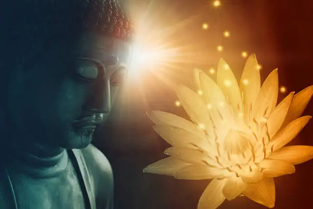 Photo of peace buddha face enlighten with golden lotus light of Buddhist peace