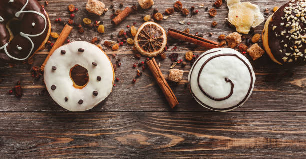 istock Assorted donuts on wooden background with copy space. Close view, flat lay 1048603516