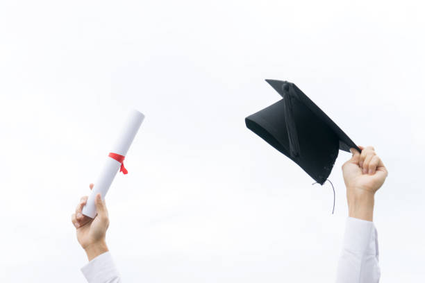 istock young man wear cap and gown graduation suit 1048603728