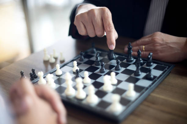 istock Businessman thinking how to play chess concept business strategy 1048613624