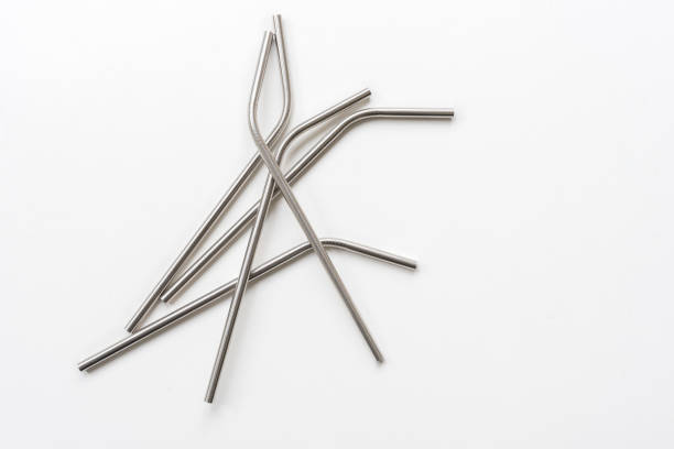 istock Metal straws randomly arranged on white background from above 1048616402
