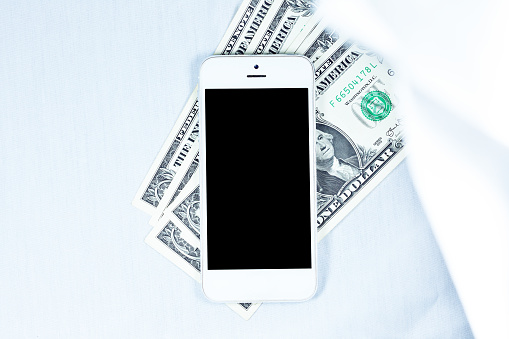 Smart phone dollar on white background in concept saving money investment shopping pay and people richness banknote shopping online technology Business close-up communication