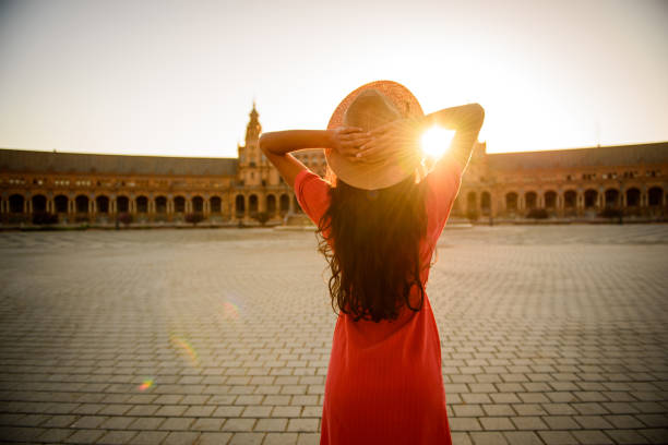 Woman enjoying sunrise. Woman enjoying sunrise above Plaza de Espana in Seville, Spain seville stock pictures, royalty-free photos & images