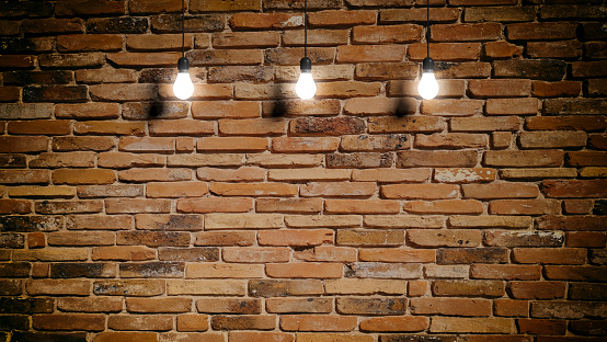 3d rendering light bulbs hanging on brick wall background