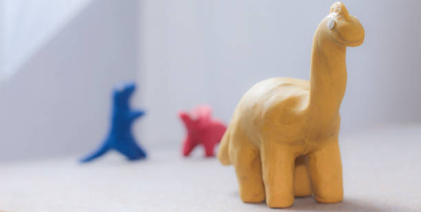 istock dinosaur figures of cheerful colors 1048647196
