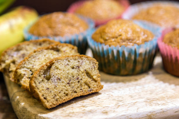 istock Banana Cupcake slide on a wooden cutting board. 1048647270