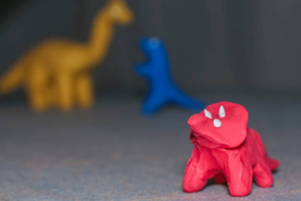 istock dinosaur figures of cheerful colors 1048647654