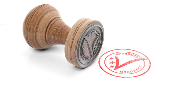 istock Wooden round rubber stamper and stamp with text approved isolated on white background. 3d illustration 1048647788